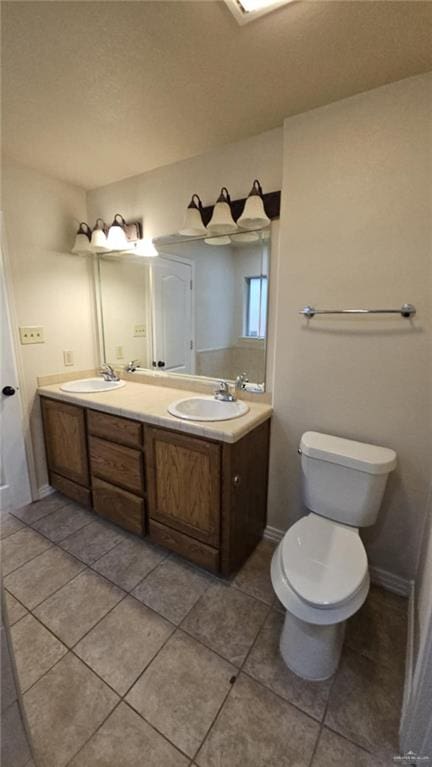 bathroom featuring tile patterned flooring, vanity, and toilet