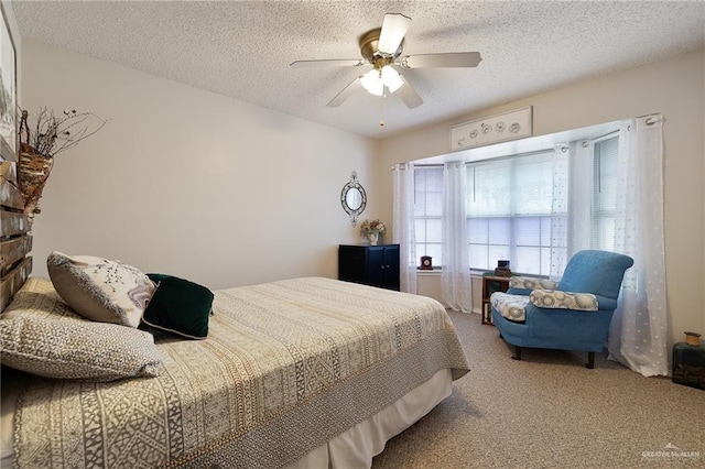 carpeted bedroom with a textured ceiling and ceiling fan