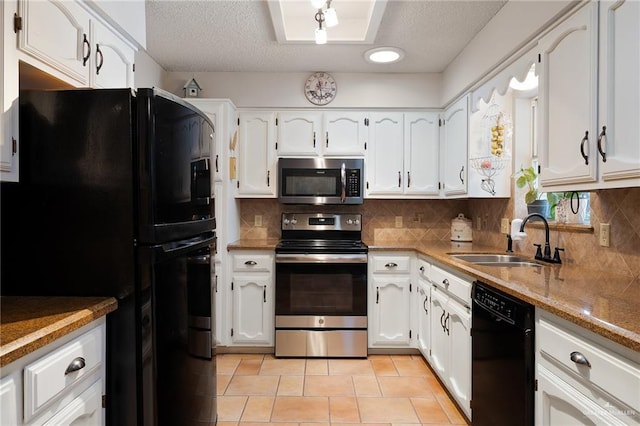 kitchen featuring sink, backsplash, white cabinetry, and black appliances