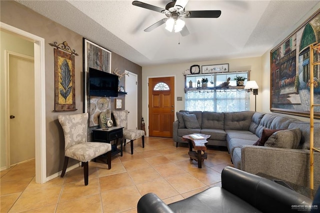 tiled living room featuring ceiling fan and a textured ceiling