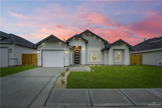 view of front of home featuring a garage and a yard