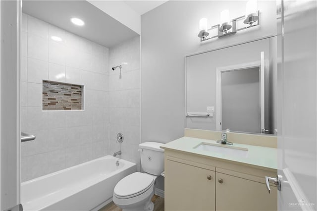 full bathroom featuring vanity, toilet, and tiled shower / bath combo