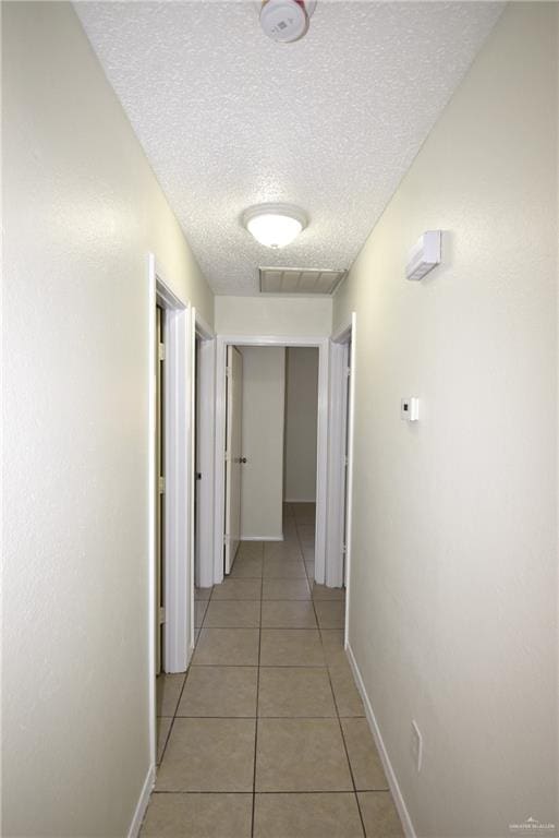202 E Cardinal Ave, Pharr, TX 78577 - hall with a textured ceiling, light tile patterned floors, and baseboards