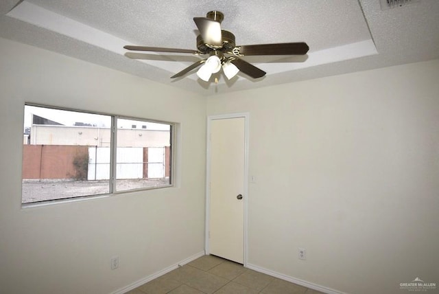 202 E Cardinal Ave, Pharr, TX 78577 - empty room with baseboards, ceiling fan, light tile patterned flooring, and a raised ceiling