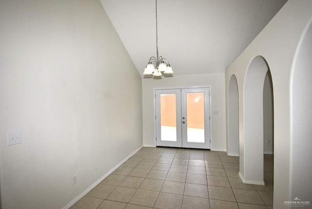 202 E Cardinal Ave, Pharr, TX 78577 - unfurnished dining area featuring french doors, light tile patterned floors, baseboards, vaulted ceiling, and a chandelier