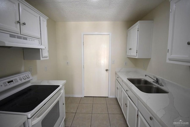 202 E Cardinal Ave, Pharr, TX 78577 - kitchen featuring white electric range, under cabinet range hood, a sink, white cabinets, and a textured ceiling