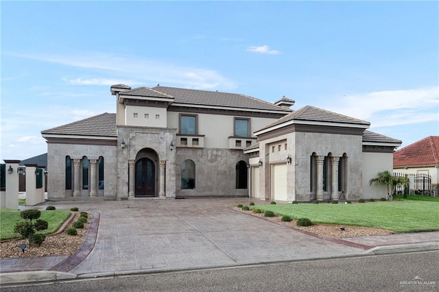 view of front of house with a garage and a front lawn