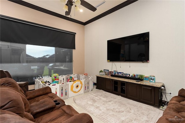 tiled living room with ceiling fan and crown molding