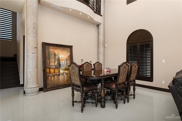 dining room featuring tile patterned flooring and a high ceiling