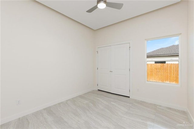 unfurnished bedroom featuring a closet and ceiling fan