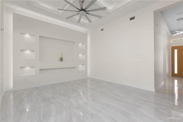 unfurnished living room featuring ceiling fan, coffered ceiling, beam ceiling, and a high ceiling