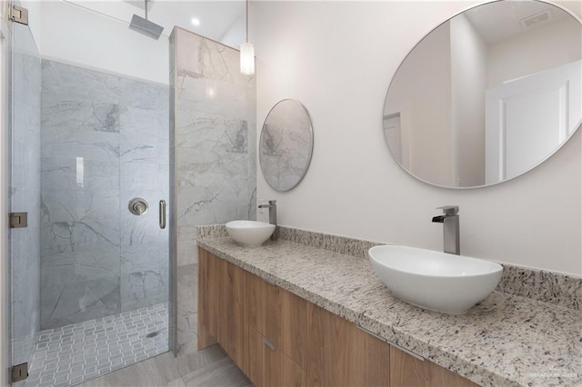 bathroom with vanity and a shower with shower door