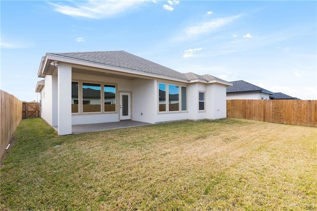 rear view of house with a patio area and a lawn