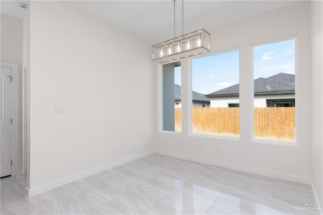 unfurnished dining area featuring light tile patterned floors and a healthy amount of sunlight