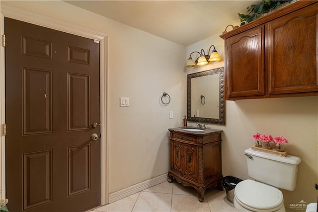 bathroom with tile patterned flooring, vanity, and toilet