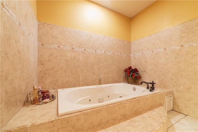 bathroom with a relaxing tiled tub, tile patterned floors, and tile walls