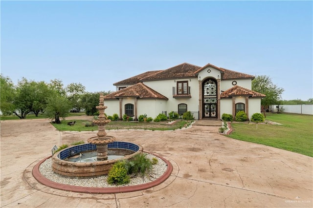 mediterranean / spanish-style home featuring a front lawn