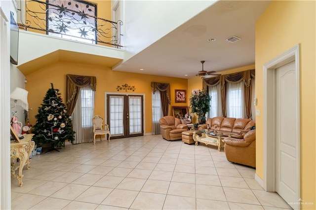 living room with ceiling fan, french doors, and light tile patterned floors