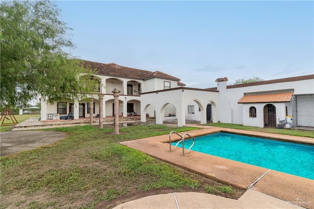 back of property featuring a patio area and a balcony