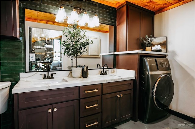 420 N Mayberry Rd, Alton, TX 78573 - bathroom with washer / clothes dryer, double vanity, and tasteful backsplash