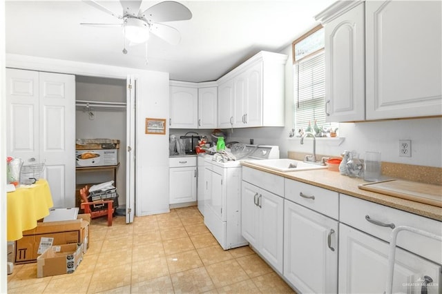 kitchen featuring ceiling fan, a sink, white cabinets, light countertops, and independent washer and dryer