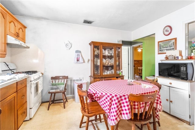 dining space featuring light floors and visible vents