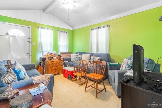 living area with a ceiling fan and lofted ceiling with beams