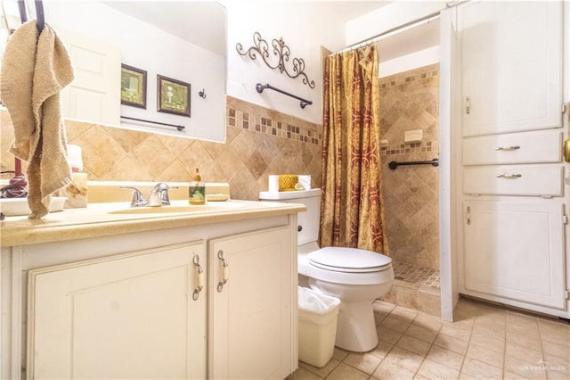 full bathroom featuring tile walls, toilet, a stall shower, vanity, and tile patterned floors