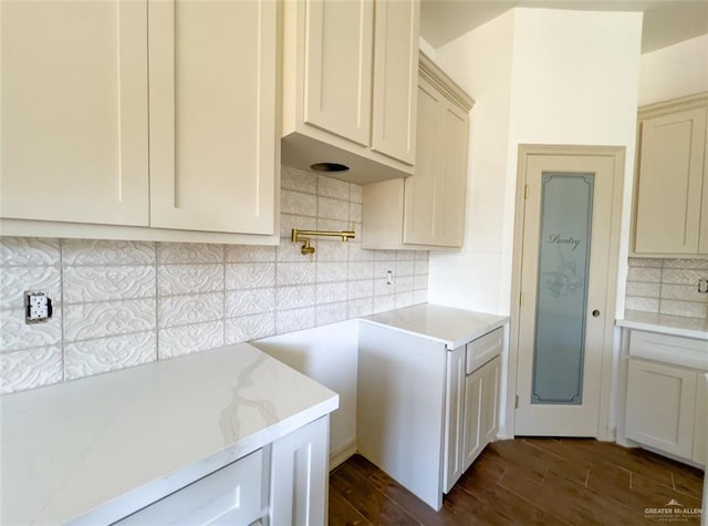 kitchen featuring light stone counters and tasteful backsplash