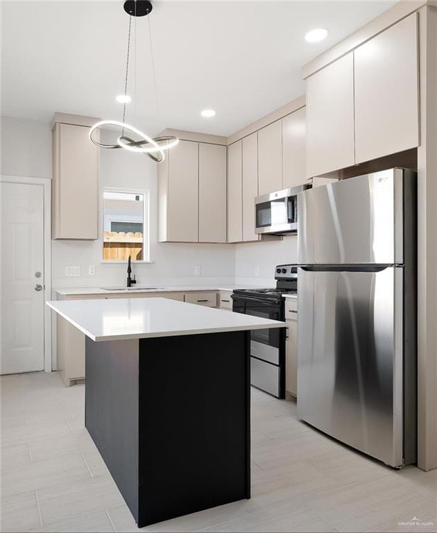 kitchen featuring a kitchen island, hanging light fixtures, stainless steel appliances, light countertops, and a sink