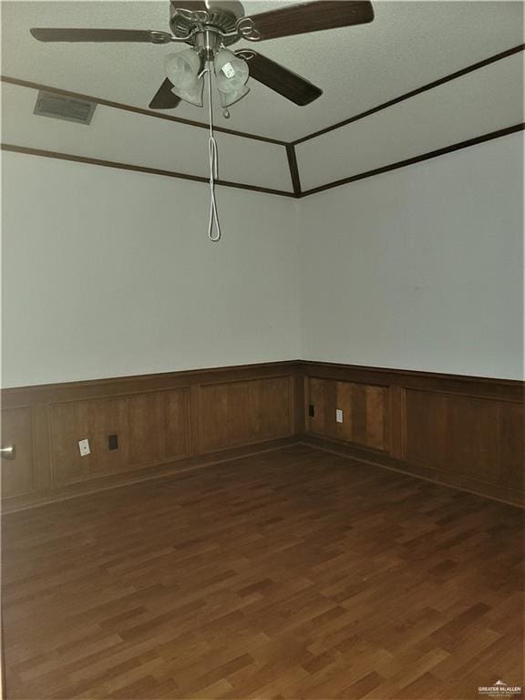 spare room with ceiling fan and dark wood-type flooring