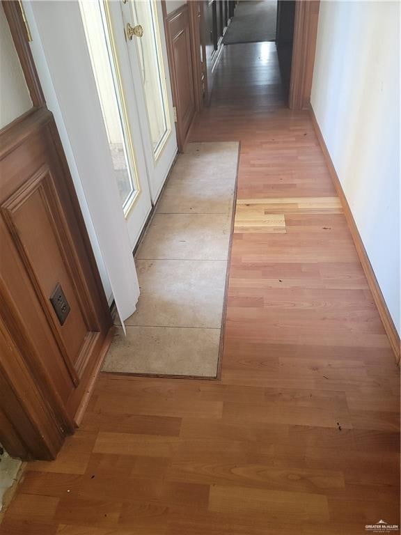 corridor with light hardwood / wood-style flooring