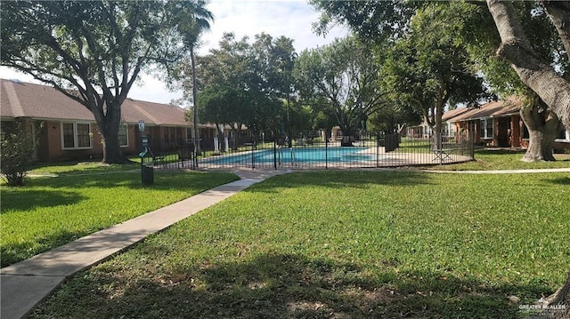 view of swimming pool with a lawn