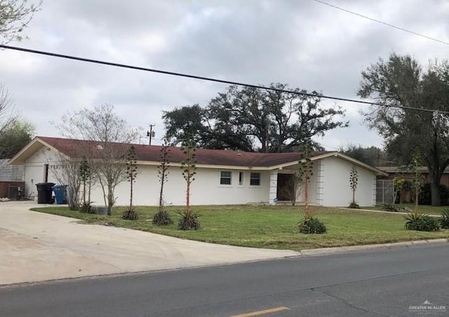 ranch-style home featuring a front yard and a garage