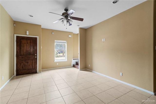 tiled empty room with ceiling fan