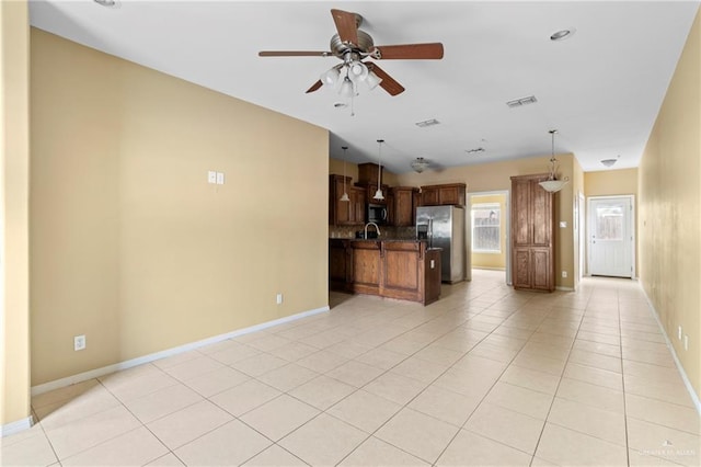 kitchen with ceiling fan, kitchen peninsula, decorative light fixtures, light tile patterned floors, and appliances with stainless steel finishes