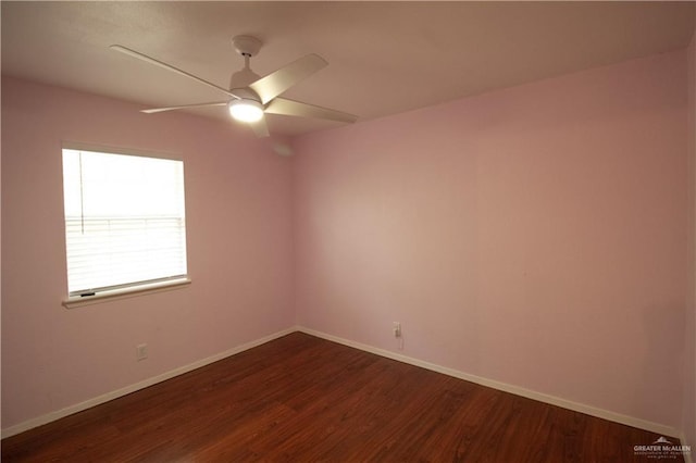 unfurnished room featuring baseboards, dark wood-style floors, and ceiling fan
