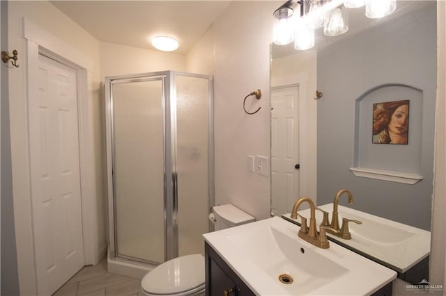full bath featuring toilet, vanity, and a stall shower