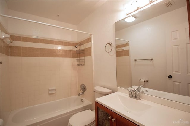 bathroom with visible vents, toilet, vanity, and shower / washtub combination