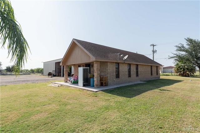 rear view of house featuring a yard