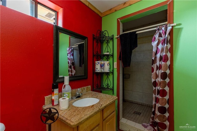 bathroom with tile patterned flooring, vanity, and walk in shower