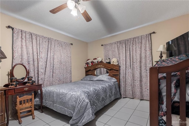 tiled bedroom with a textured ceiling and ceiling fan