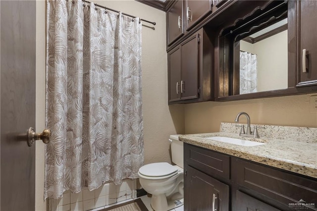 bathroom with tile patterned flooring, vanity, toilet, and crown molding