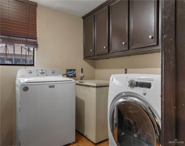 laundry area with cabinets and washing machine and clothes dryer