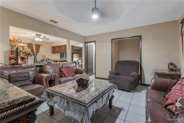 living room with light tile patterned floors and ceiling fan