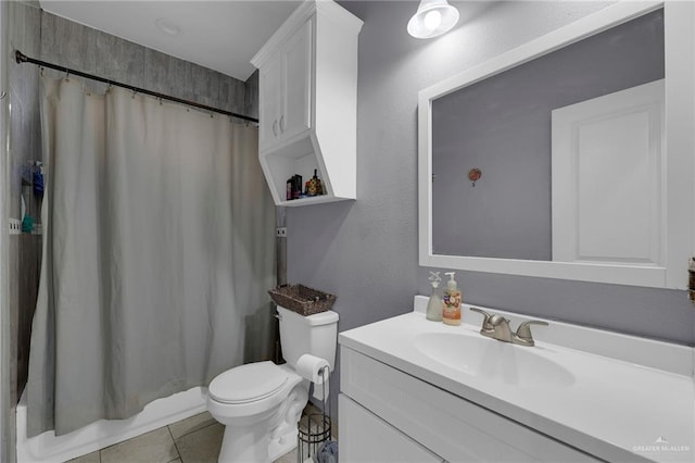 bathroom with tile patterned flooring, vanity, toilet, and curtained shower