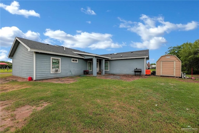 rear view of property with a storage shed and a yard