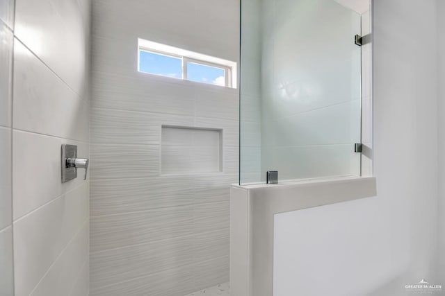 bathroom with a tile shower