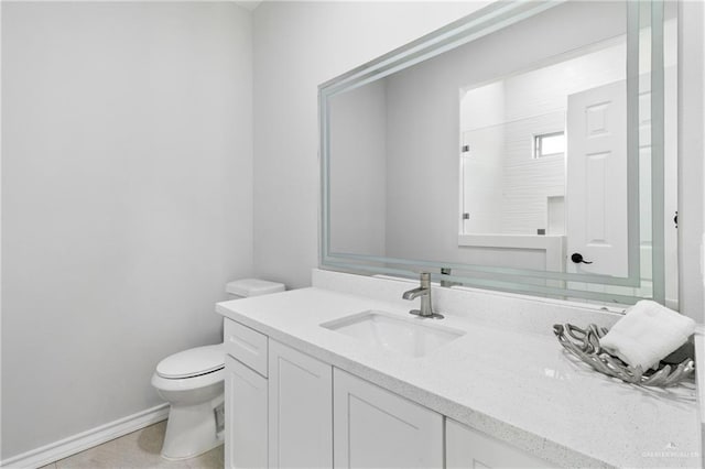 bathroom featuring vanity, toilet, and walk in shower