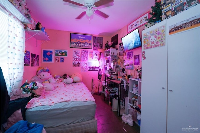 tiled bedroom featuring ceiling fan